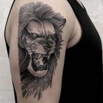 Angry lion tattoo on the right arm