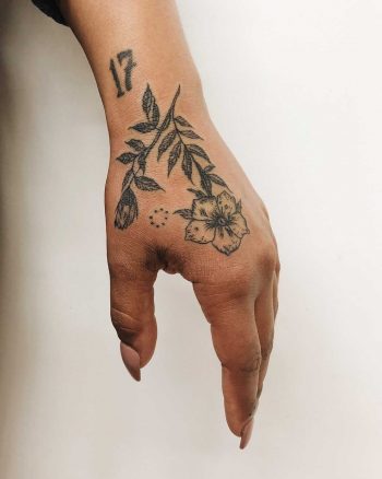 Beautiful flower tattoos on the left hand and wrist