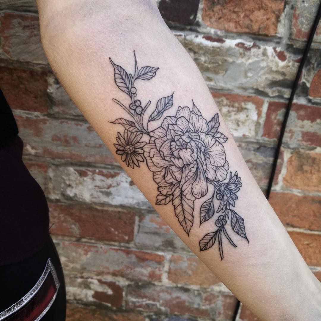 Black and grey peony tattoo on the forearm