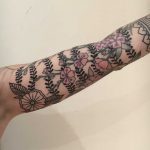 Black and pink flowers wrapped around the arm