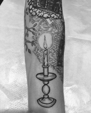 Blackwork burning candle in a holder