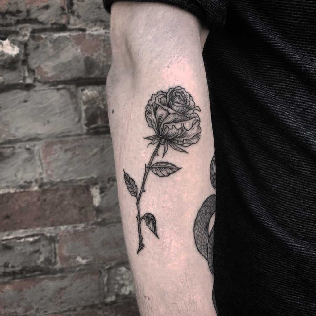 Blackwork rose stem tattoo