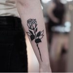 Blackwork rose tattoo on the forearm by Jonas Ribeiro