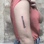 Bobby pin tattoo on the arm