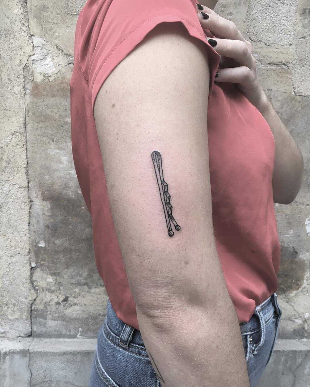 Bobby pin tattoo on the arm 