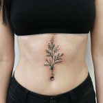 Botanical design tattoo on the belly