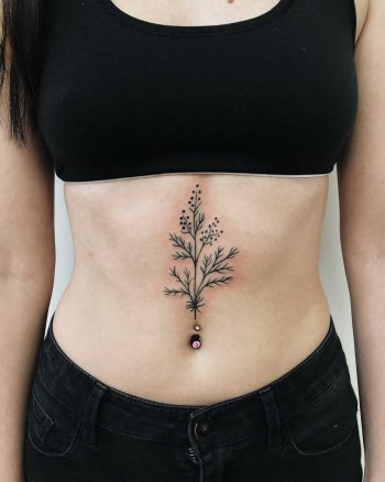 Botanical design tattoo on the belly