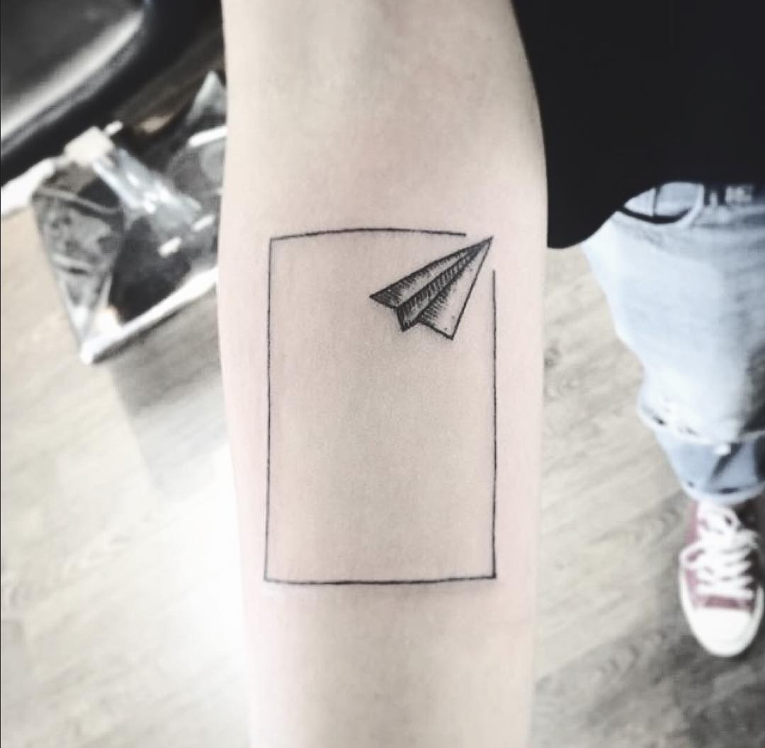 Boxed paper plane tattoo by Unkle Gregory