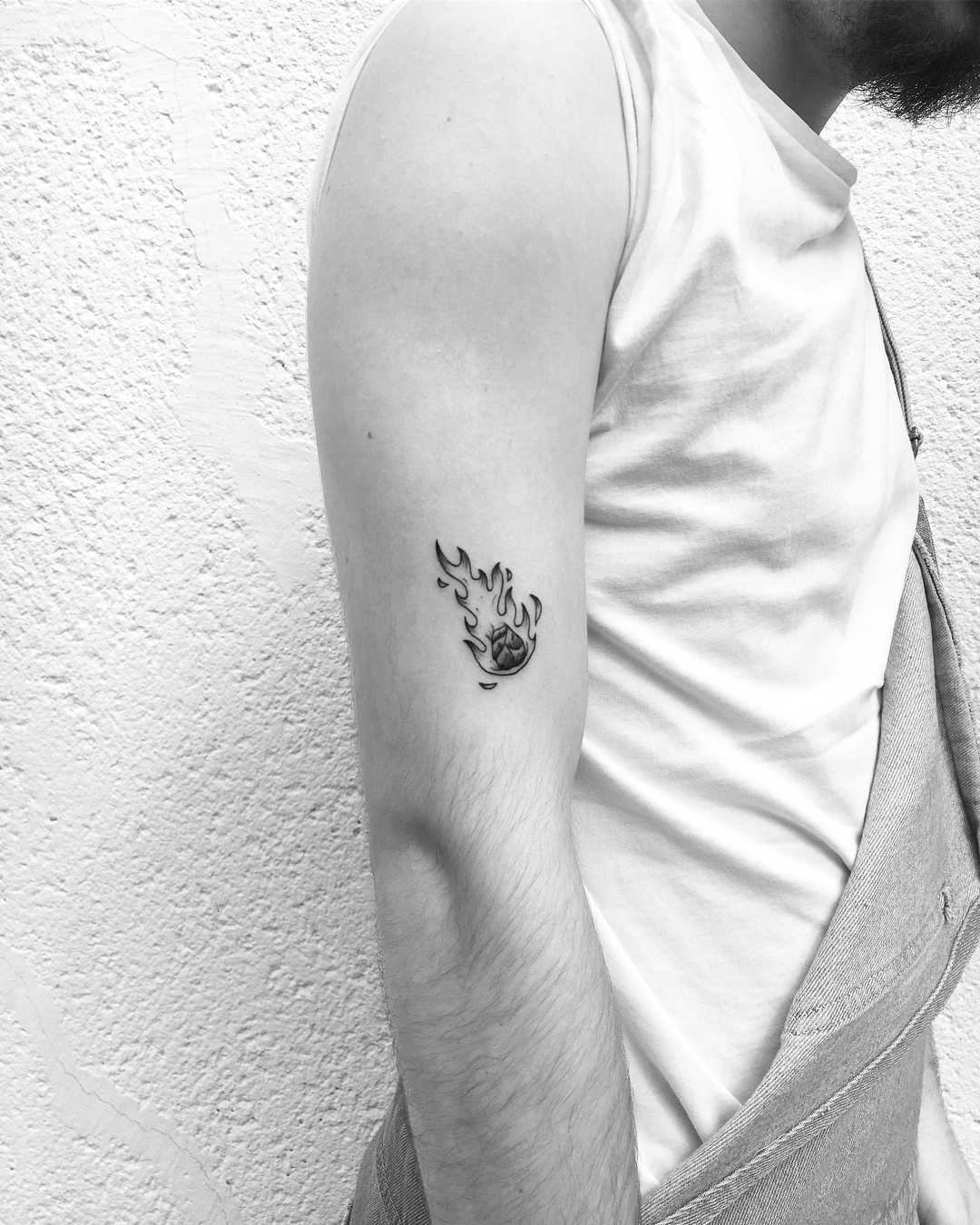 Burning comet tattoo on the arm