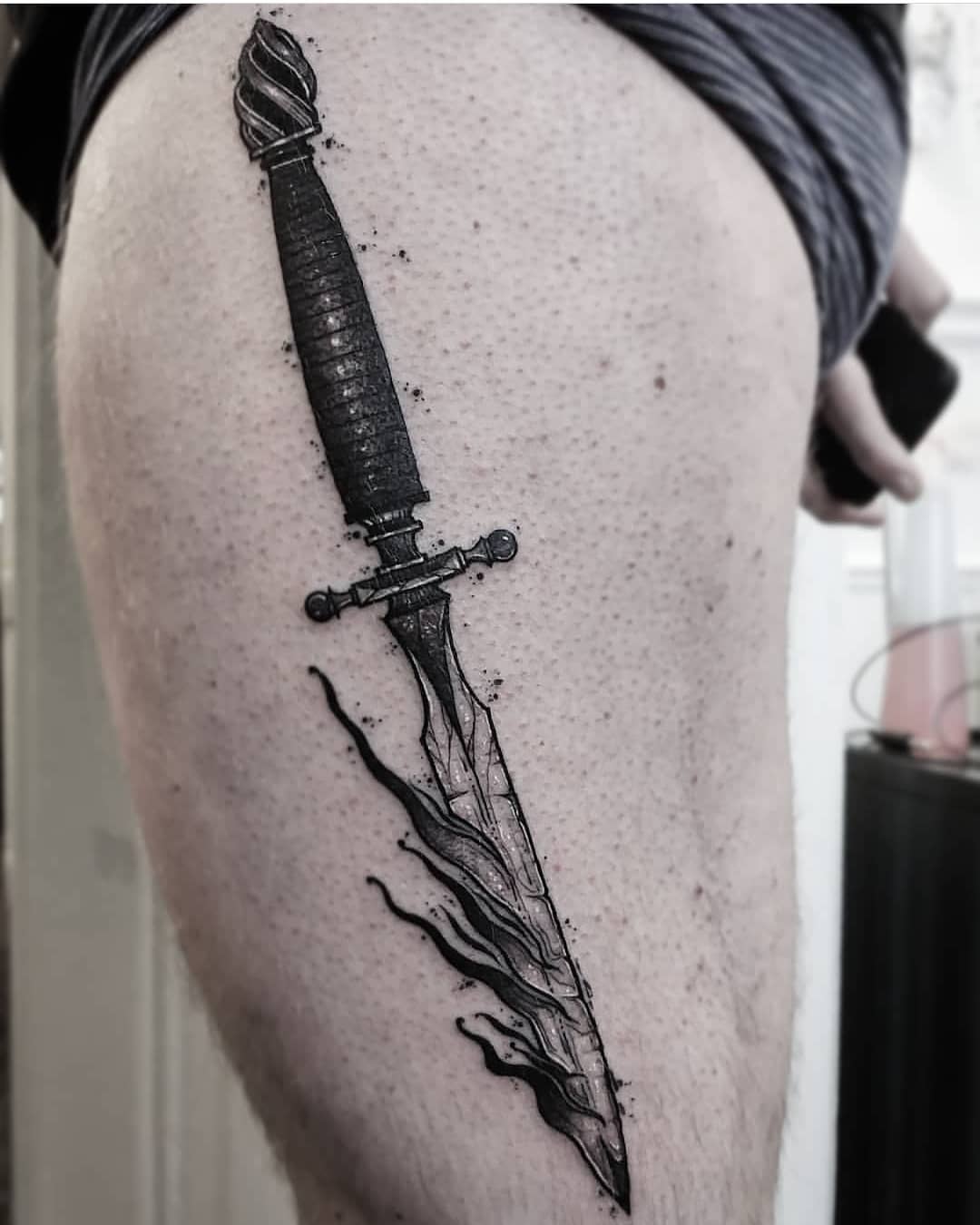 Burning dagger tattoo
