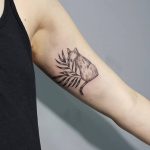 Cat and palm branch tattoo