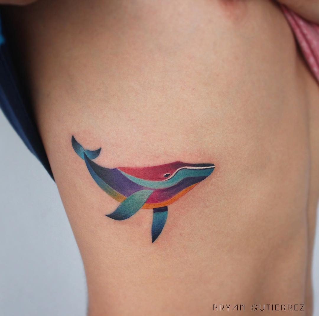 Colorful whale tattoo on the rib cage