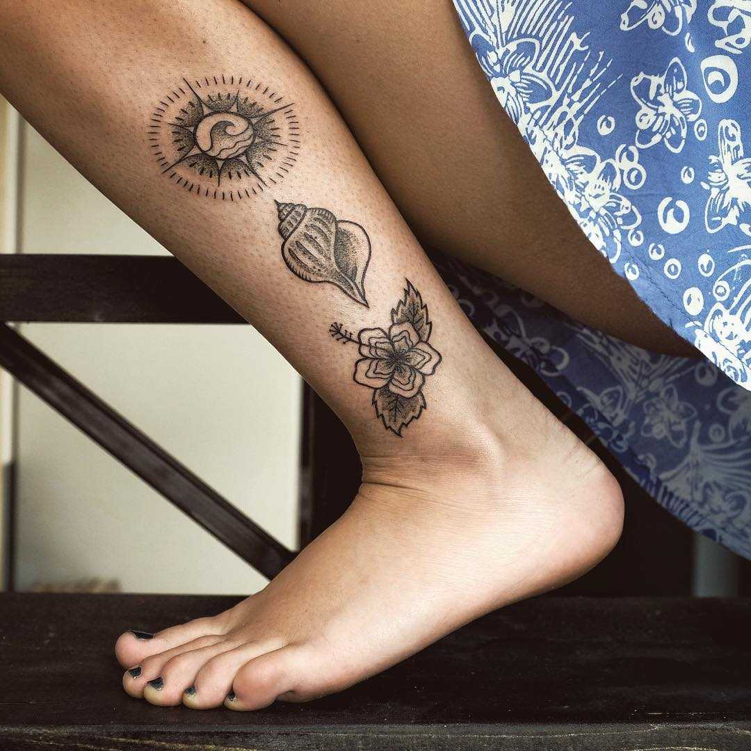 Compass, seashell, and flower tattoo