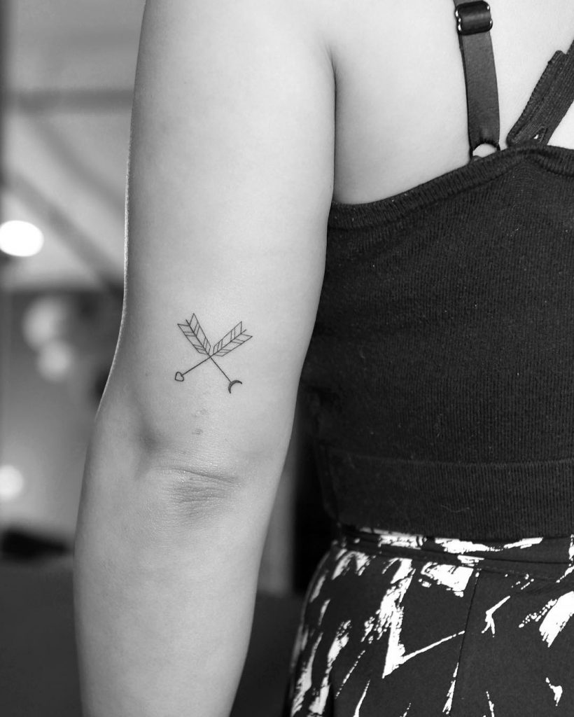Crossed arrows done at Fine Line Tattoo