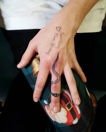 Cute snake tattoo on the middle finger