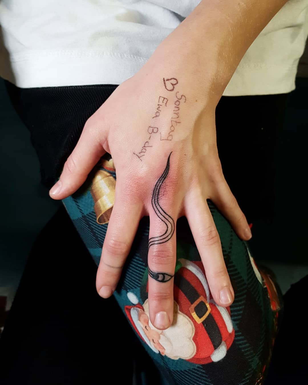 Cute snake tattoo on the middle finger