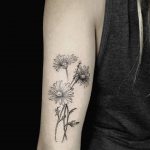 Daisies tattoo on the triceps