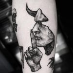 Devil tattoo on the forearm