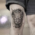Devil tattoo on the thigh