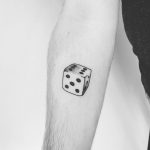 Dice tattoo on the forearm