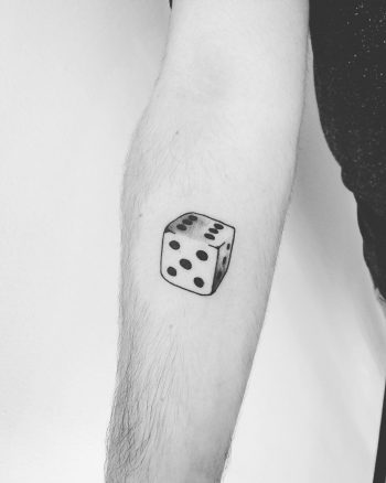 Dice tattoo on the forearm