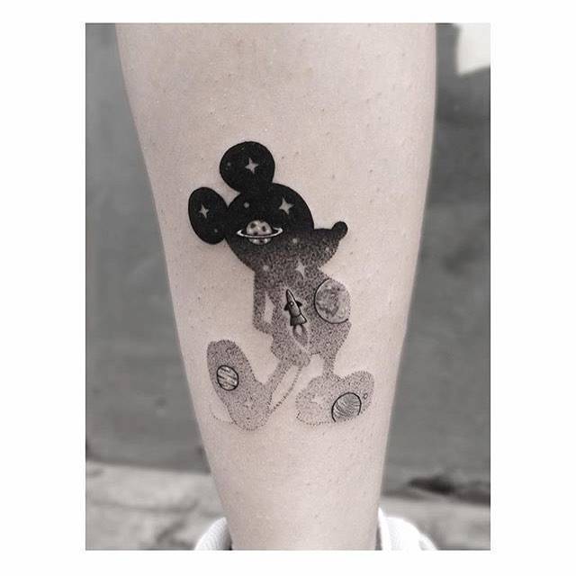 Wrist tattoo of Mickey Mouse.