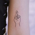 Fingers crossed tattoo