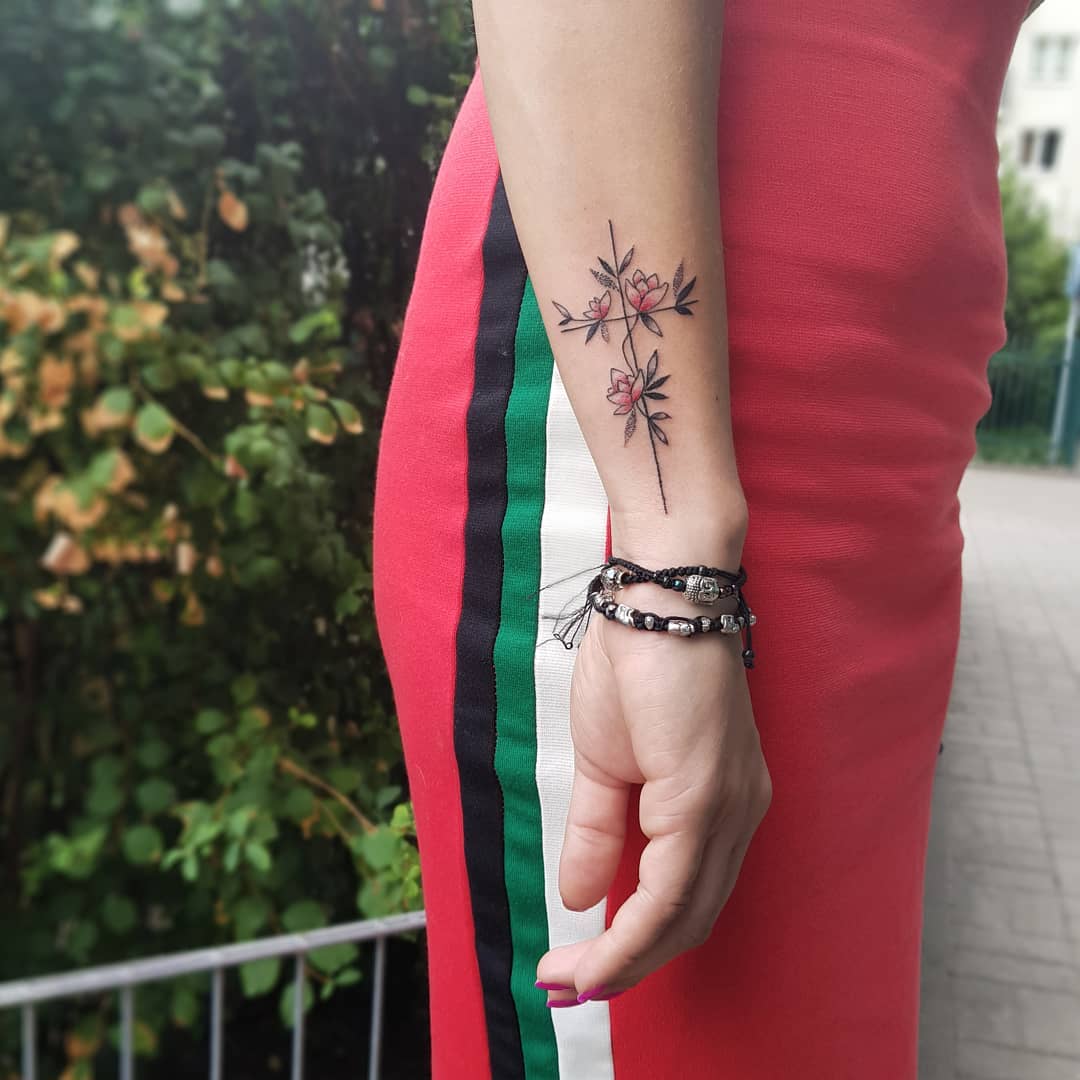 Floral cross tattoo on the wrist