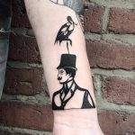 Gentleman and bird tattoo
