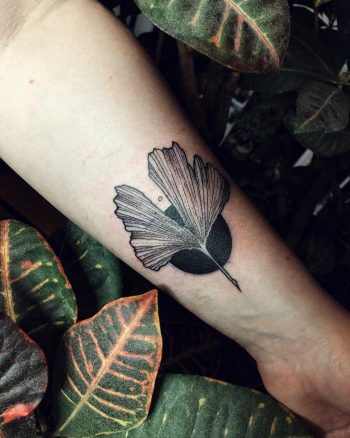 Ginkgo leaf and a black circle tattoo