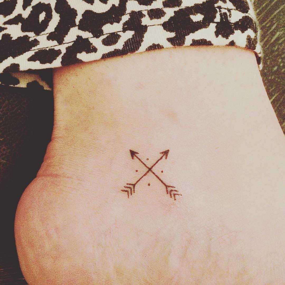 Hand-poked crossed arrows tattoo - Tattoogrid.net