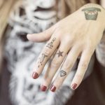Hand-poked sword tattoo on the finger