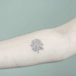 Hand-poked tree tattoo on the forearm