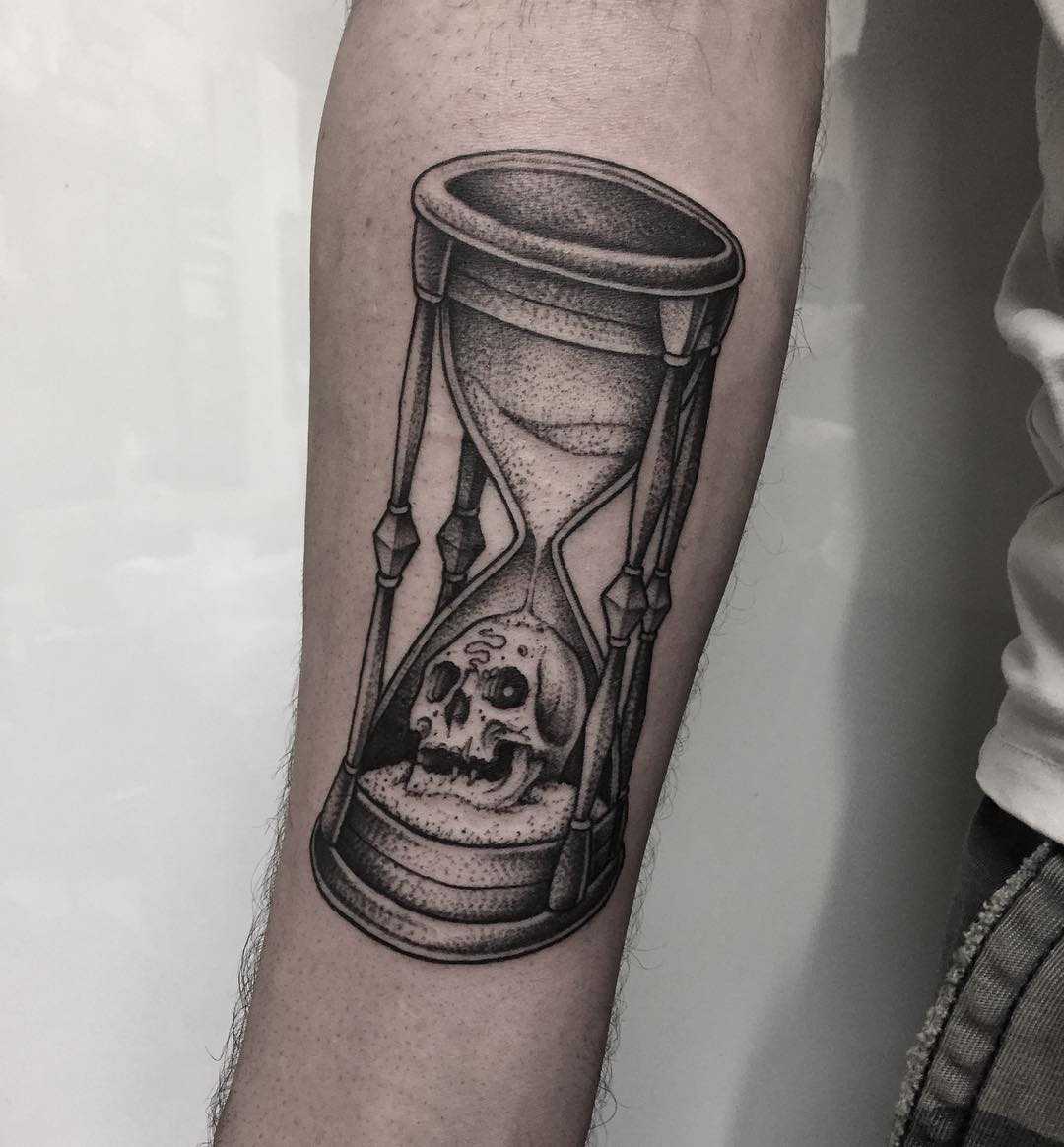 Hourglass and skull done at Primordial Pain Tattoo