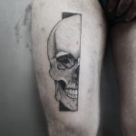 Hyper-realistic half skull tattoo