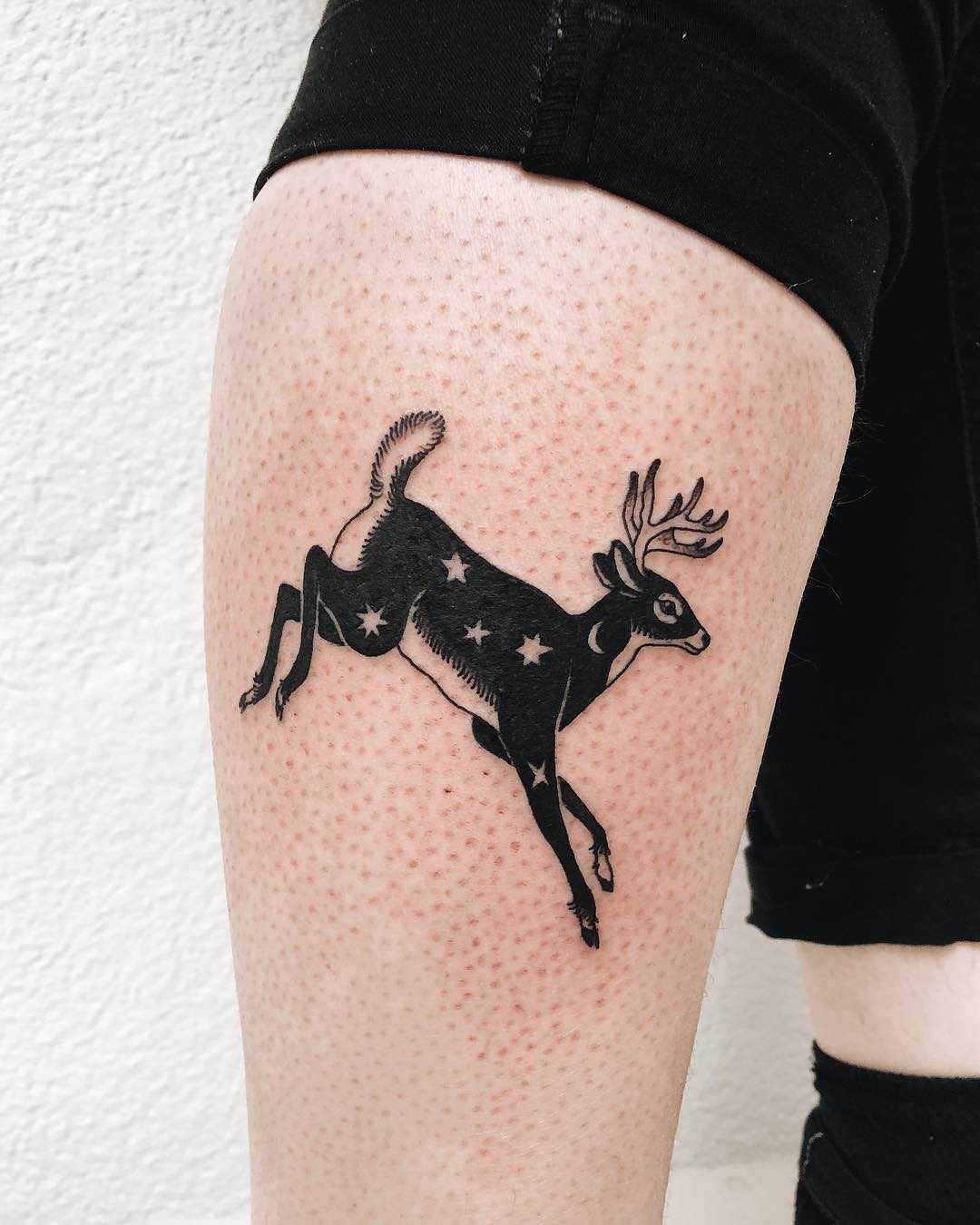 Jumping deer tattoo on the calf