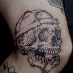 Knee skull tattoo