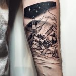 Lighthouse and mountains tattoo