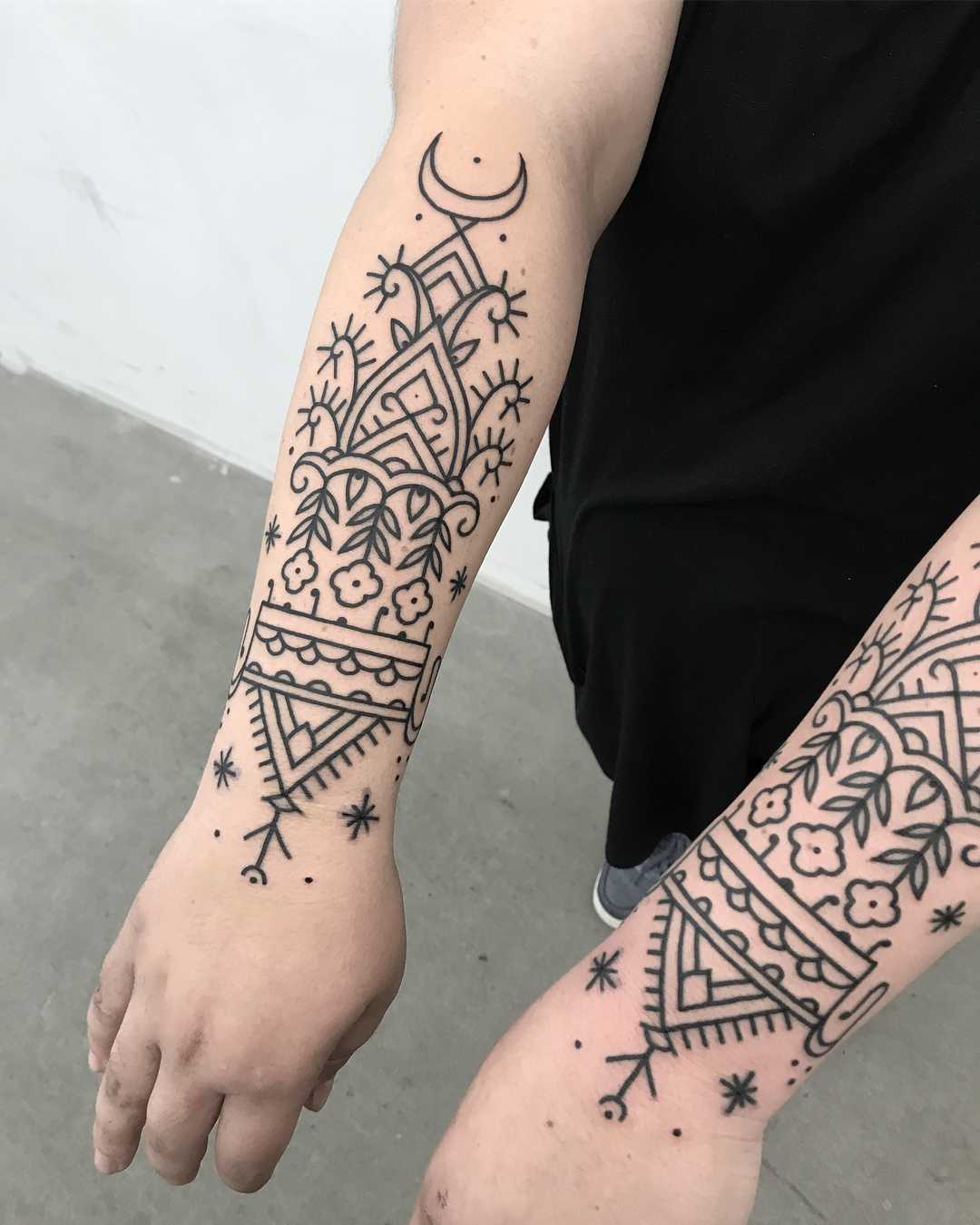 Matching black pattern tattoos