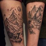 Matching landscape tattoos on forearms