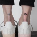 Matching lotus tattoos on ankles