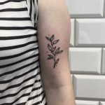 Minimalist twin with leaves inked on the arm