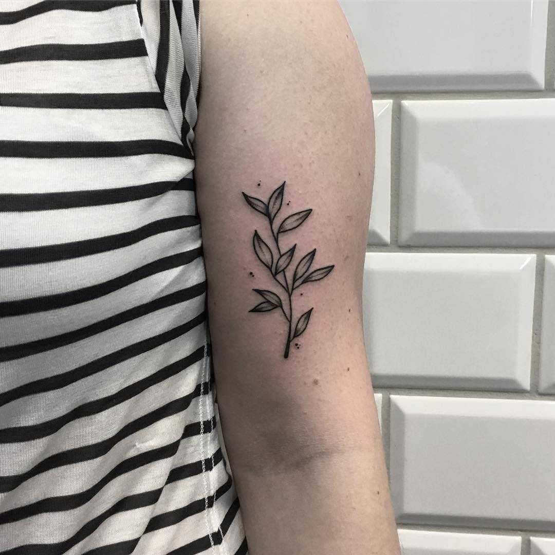 Minimalist twig with leaves inked on the arm
