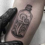 Mushrooms in a bottle done at Primordial Pain Tattoo
