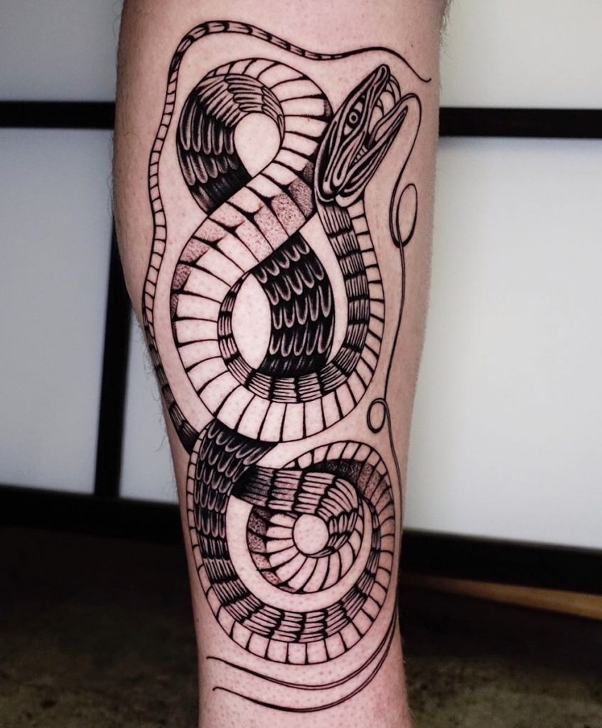 Mystical snake tattoo on the calf