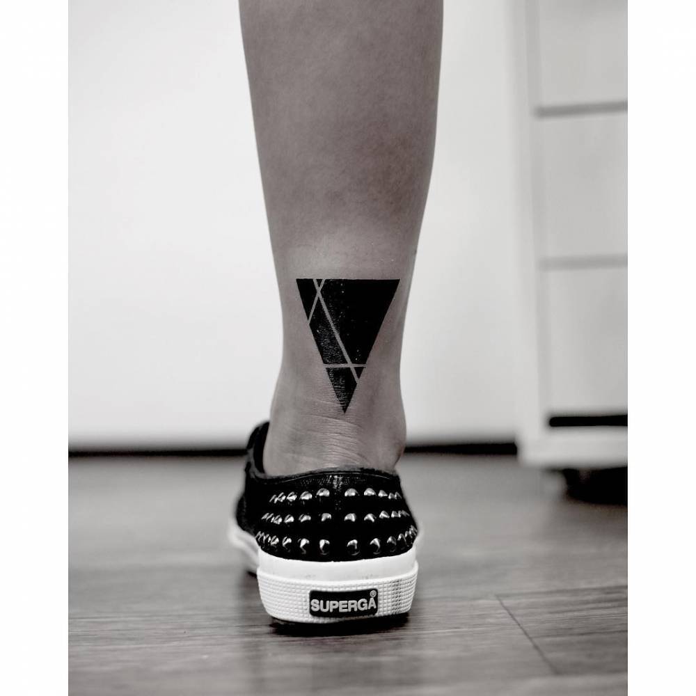 Negative space triangle tattoo by Woori, done in Suwon
