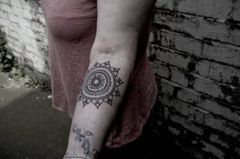 Ornamental black mandala on the forearm