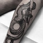 Pattada knife and snake tattoo