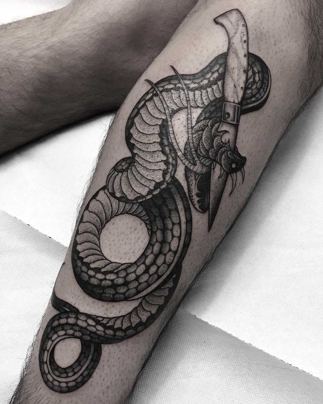 Pattada knife and snake tattoo