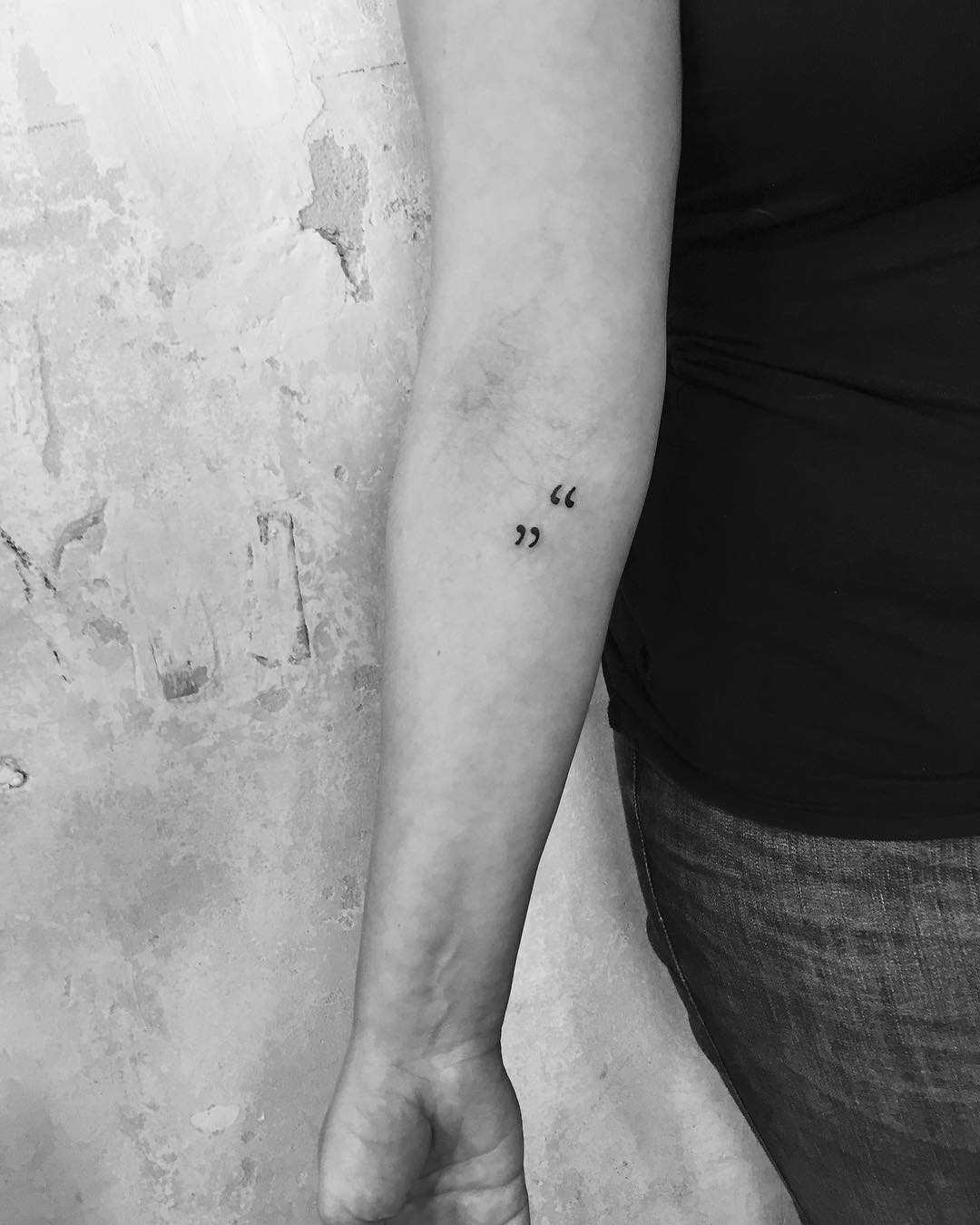 Quotation marks tattoo on the forearm